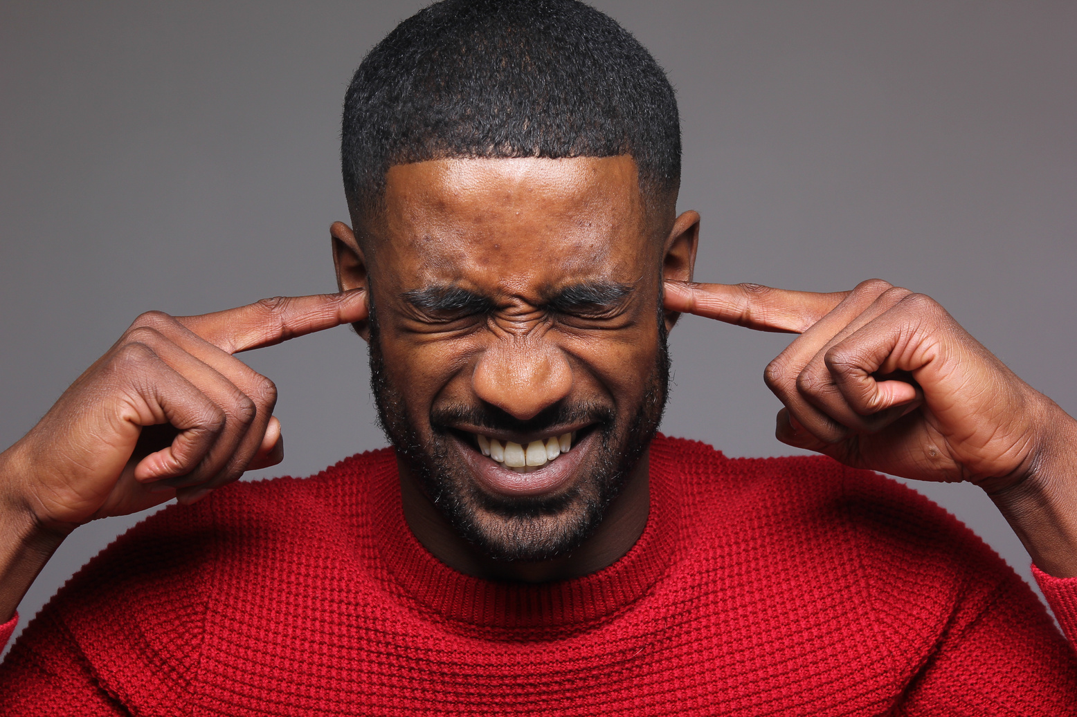 Man Covering His Ears